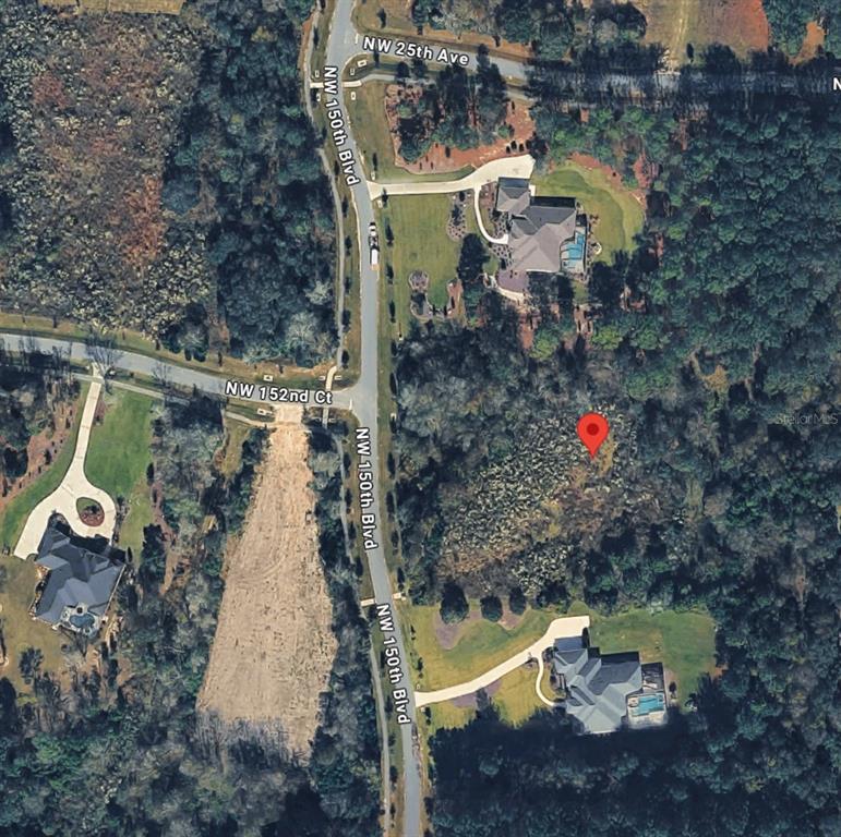 This is an aerial map view of a wooded residential lot with a red location pin — 2375 NW 150TH BOULEVARD, NEWBERRY, FL