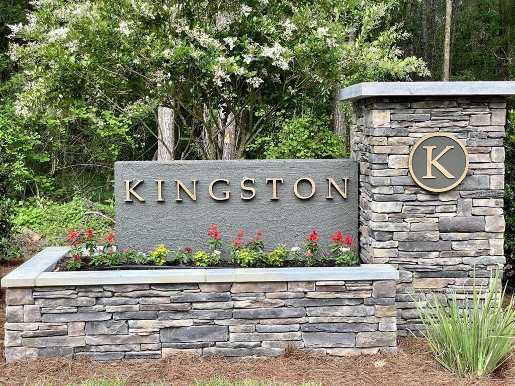 A stone monument sign with the name Kingston sits in front of a flowering tree — 2375 NW 150TH BOULEVARD, NEWBERRY, FL