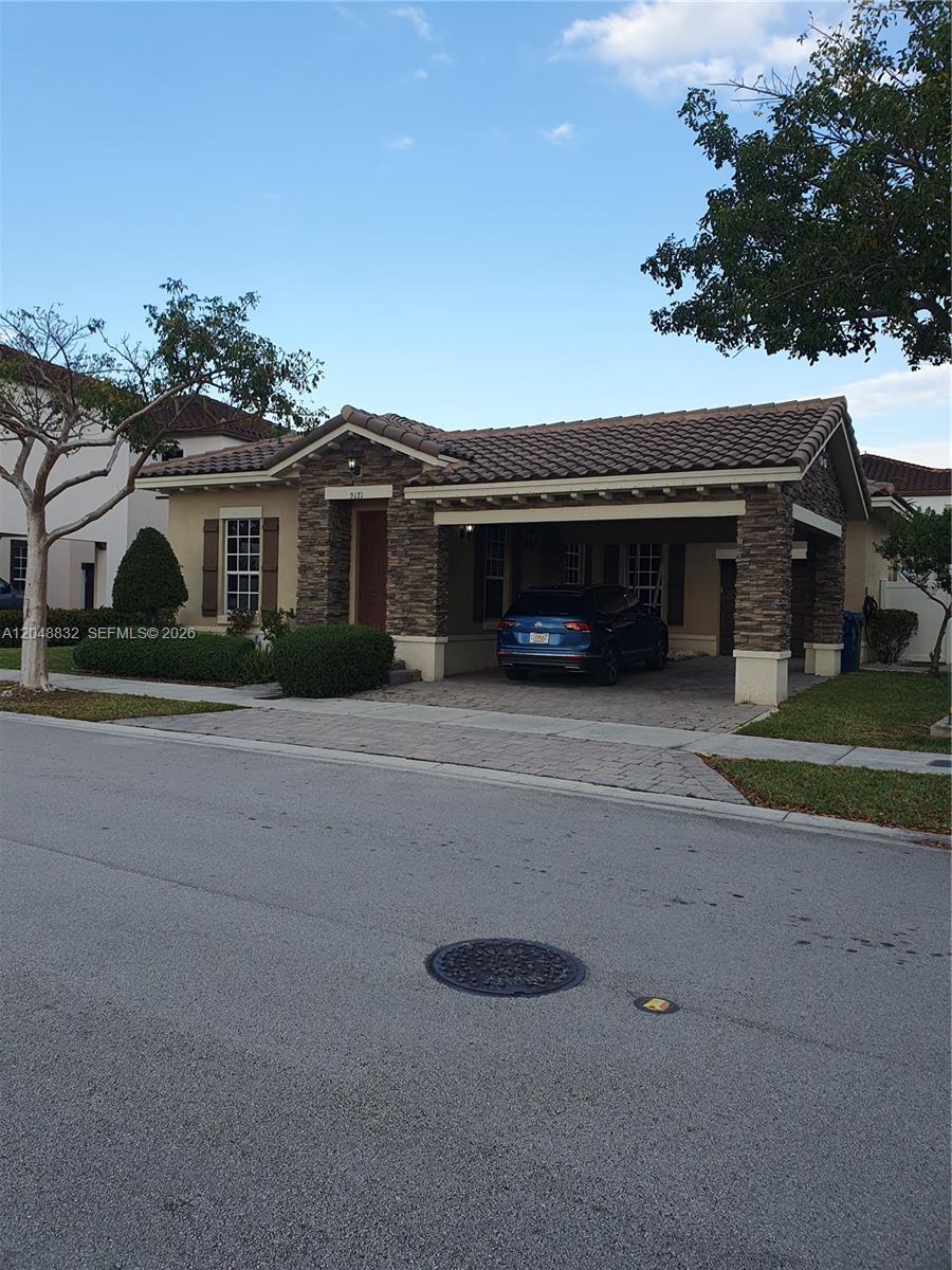 A single-story house with a stone-accented facade and a covered carport under a tiled roof — 9171 SW 169th PL # 0, Miami FL 33196, MIAMI, FL