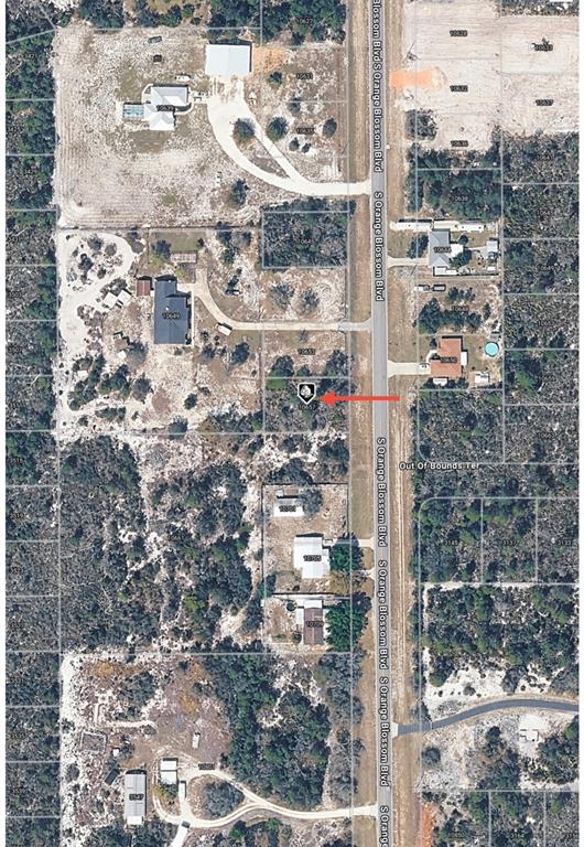 This is an aerial map view showing a vacant lot marked with a red arrow — 10657 S ORANGE BLOSSOM BOULEVARD, SEBRING, FL