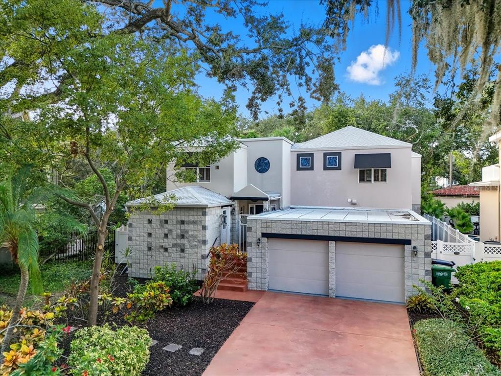 A two-story house with a stone-accented facade, a two-car garage, and a red driveway — 2713 CHAMBRAY LANE, TAMPA, FL