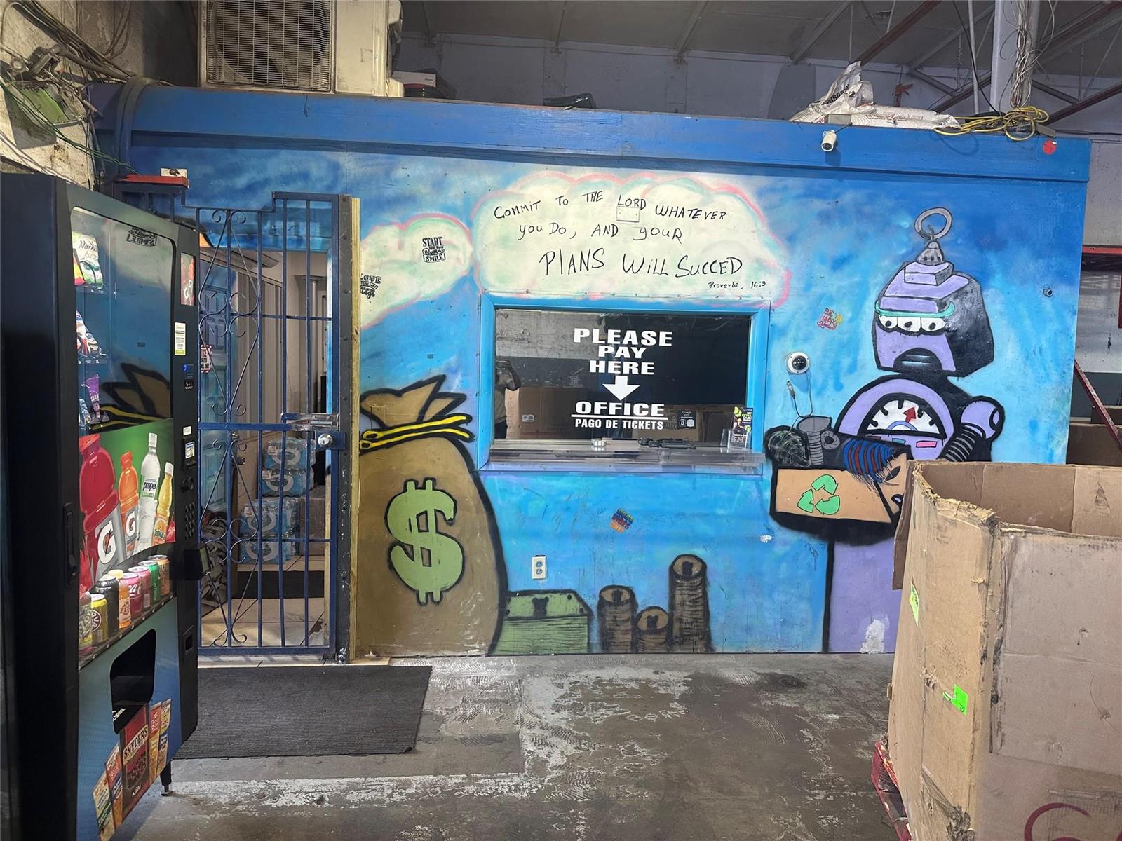 A blue wall with a service window, a money bag mural, and a vending machine — 2717 NW 34th Street, Miami FL 33142, MIAMI, FL