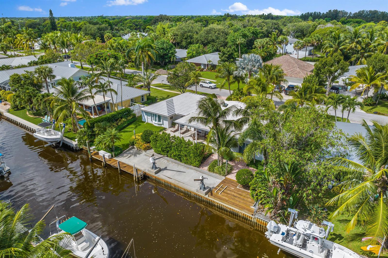 An aerial view of a waterfront house with a private dock and two boats — 18150 Perigon Way, Jupiter FL 33458, JUPITER, FL