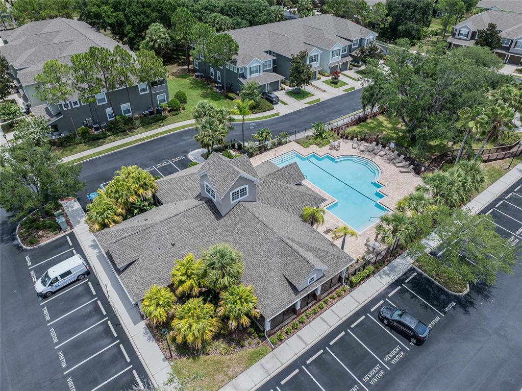 An aerial view shows a community clubhouse with a swimming pool and surrounding parking lots — 2242 KINGS PALACE DRIVE UNIT 2242, RIVERVIEW, FL
