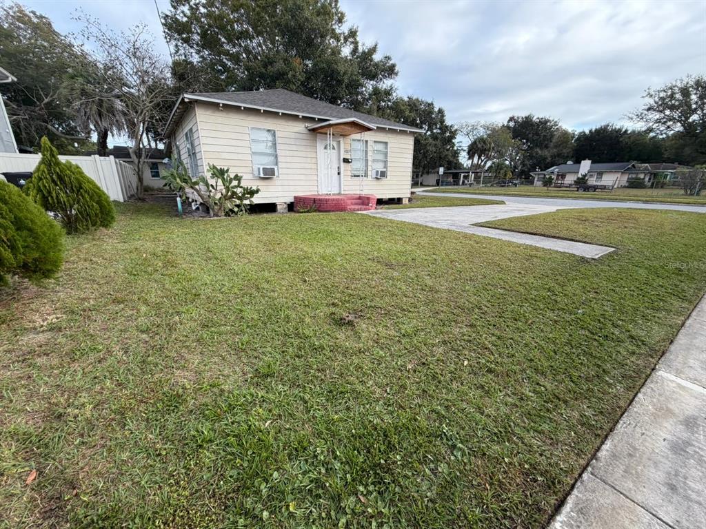 A single-story house with light-colored siding, a small front porch, and a grassy yard — 4201 CEPEDA STREET, ORLANDO, FL