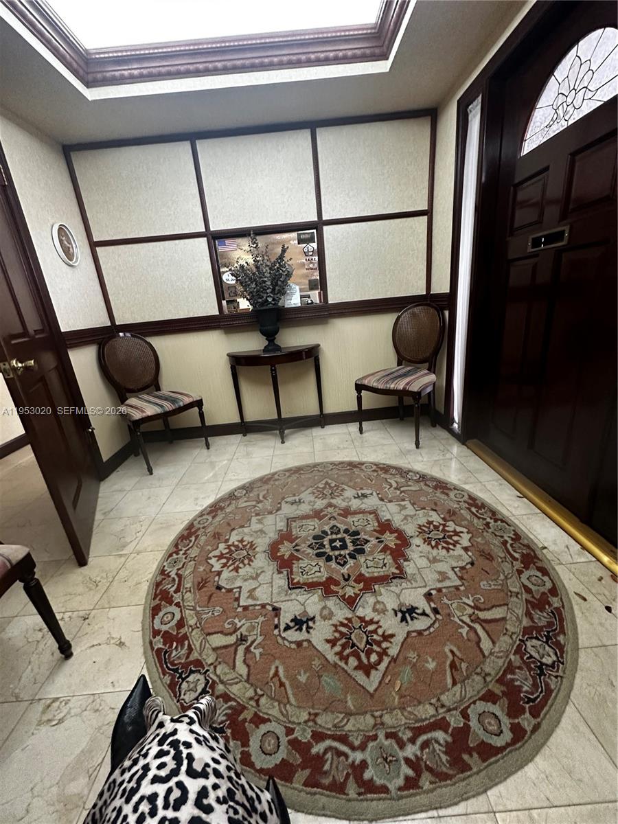 An entryway features a round rug, two chairs, a small table, and a skylight — 1105 SW 87th Ave, Miami FL 33174, MIAMI, FL