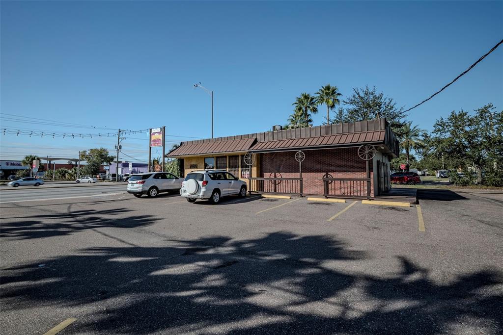 A single-story brick commercial building with a metal roof and wagon wheel decorations — 2311 W HILLSBOROUGH AVENUE, TAMPA, FL