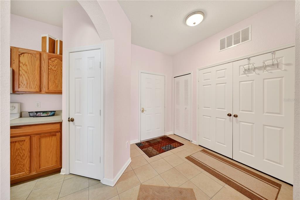 An entryway with tile flooring, white doors, a closet, and light-colored walls — 2788 ALMATON LOOP UNIT 404, KISSIMMEE, FL