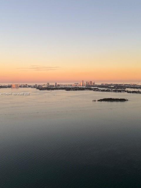 An aerial view of a calm bay with a distant city skyline at sunset — 650 NE 32nd St # 4406, Miami FL 33137, MIAMI, FL
