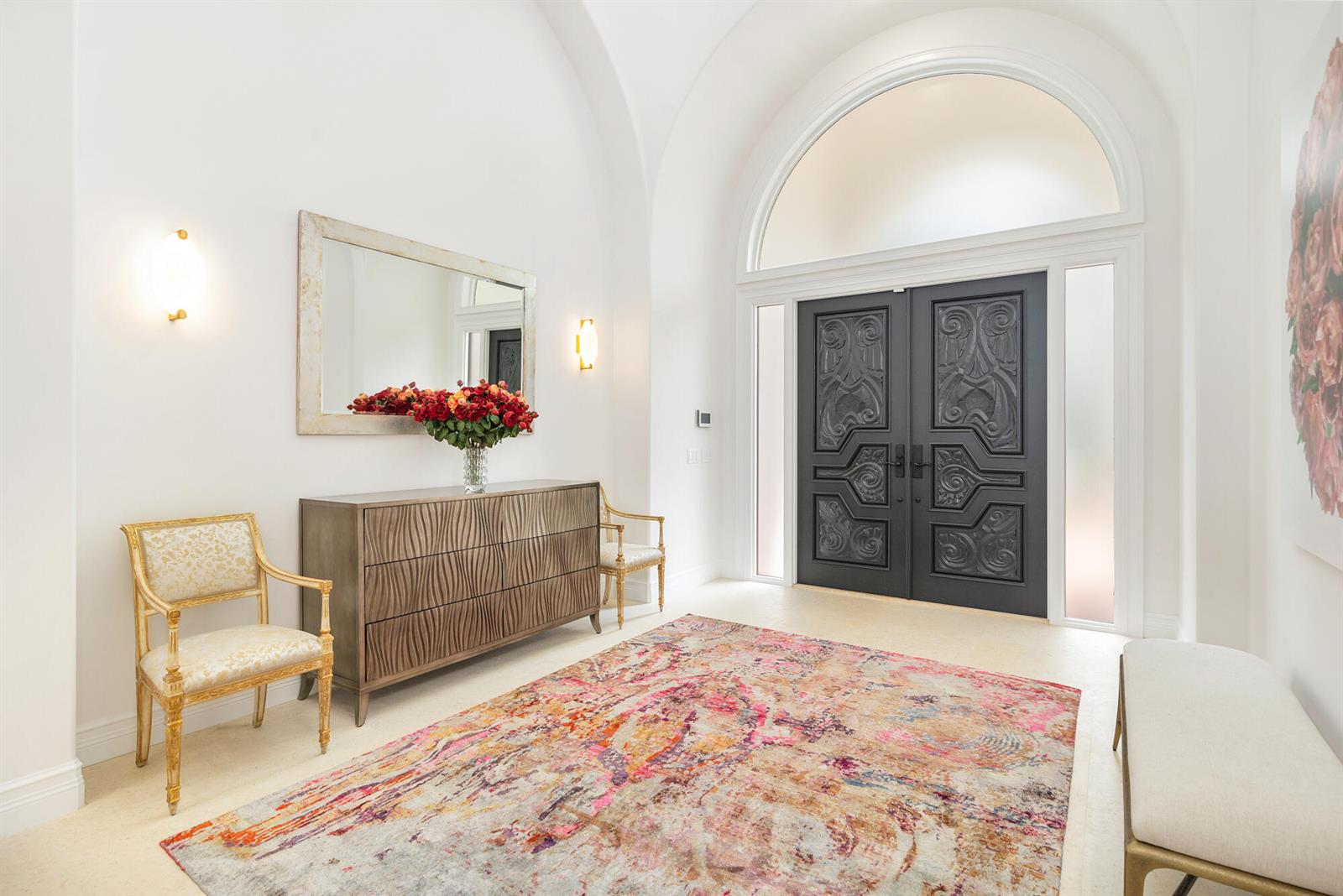 A bright foyer features a vaulted ceiling, dark double doors, a patterned rug, and furniture — 2707 Sheltingham Drive, Wellington FL 33414, WELLINGTON, FL