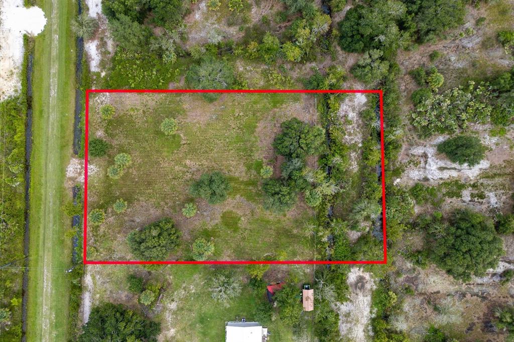 An aerial view shows a rectangular plot of land outlined in red — 17128 NW 266TH STREET, OKEECHOBEE, FL