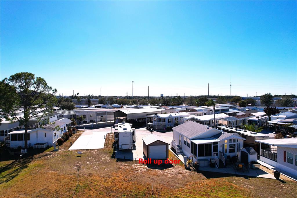 An aerial view of a mobile home park featuring a small shed with a roll-up door — 328 ST GEORGE DRIVE, DAVENPORT, FL
