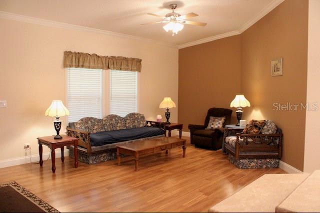 A living room features hardwood floors, a patterned sofa, a recliner, and a ceiling fan — 1759 NE 127TH STREET, BRANFORD, FL