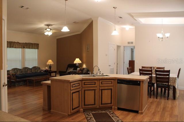 An open-concept kitchen island faces a living room and dining area with hardwood floors — 1759 NE 127TH STREET, BRANFORD, FL