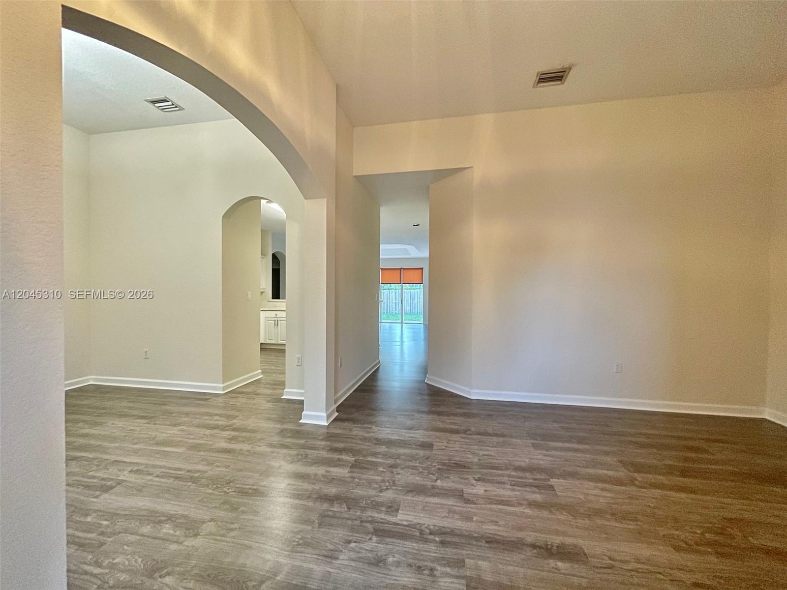 A single-story house with a brick paver driveway, a garage, and a palm tree — 2008 NE 38th Rd # 2008, Homestead FL 33033, HOMESTEAD, FL