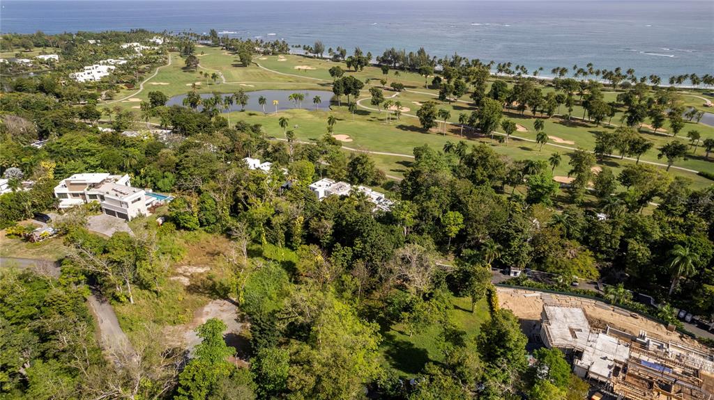 An aerial view shows a coastal golf course, lush vegetation, and several residential properties — #8 VILLA DORADO ESTATES, DORADO, PR