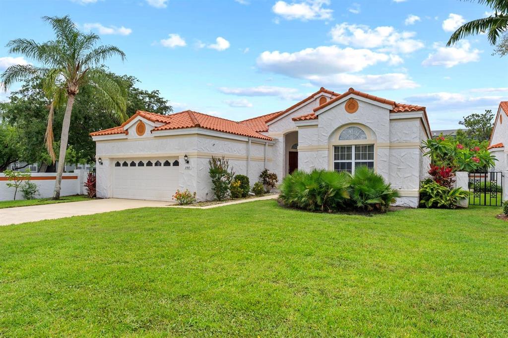 A single-story house with a white stucco exterior, orange tile roof, and a two-car garage — 2985 LA CONCHA DRIVE, CLEARWATER, FL