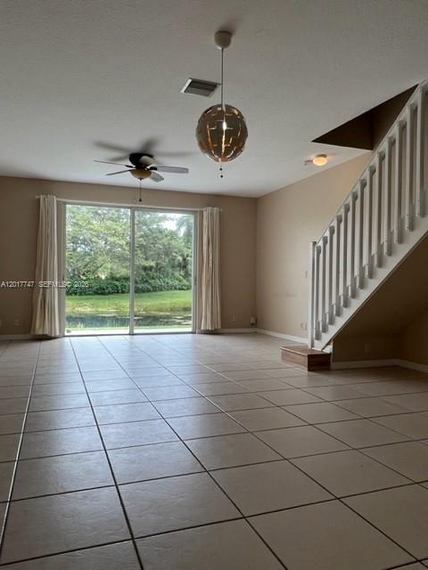 A living room features tiled floors, a ceiling fan, a pendant light, and a staircase — 2434 Cordoba Bnd # 2434, Weston FL 33327, WESTON, FL