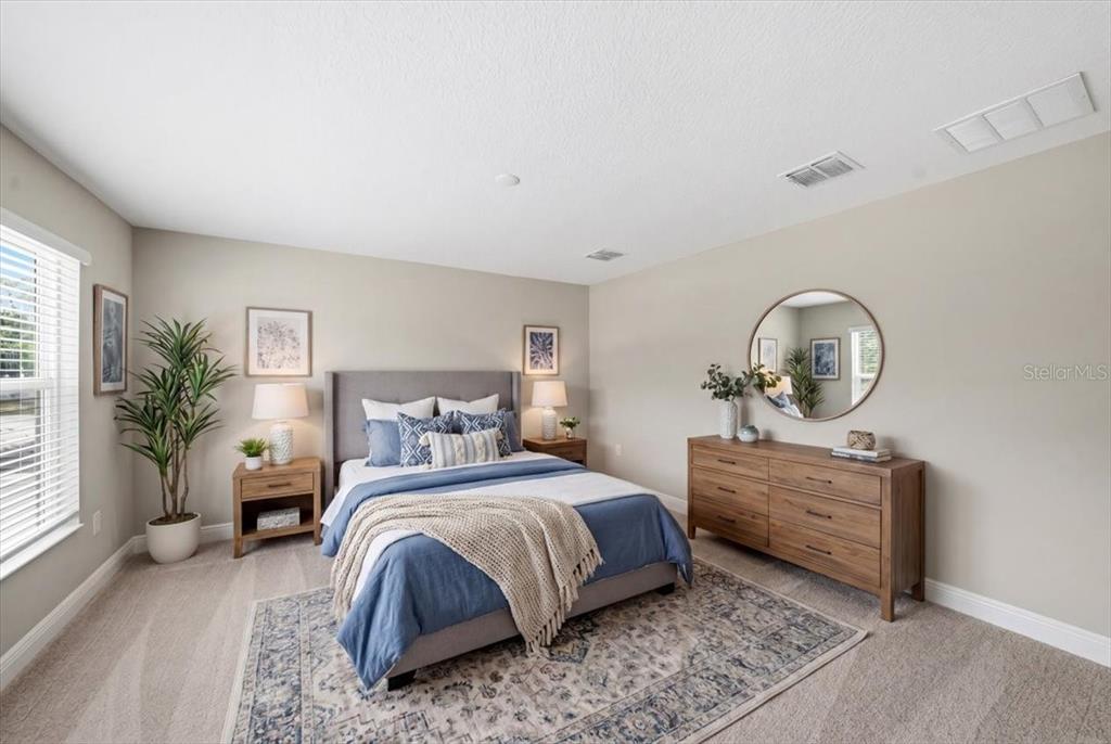A home office features a wooden desk, a rolling chair, wall art, and a large mirror — 6226 29TH STREET N, ST PETERSBURG, FL