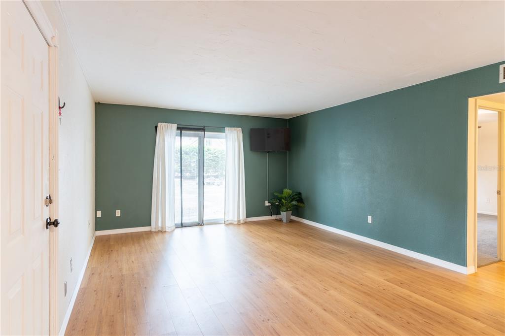 A black front door with the number 132 is centered on a tan exterior wall — 507 NW 39TH ROAD UNIT 132, GAINESVILLE, FL