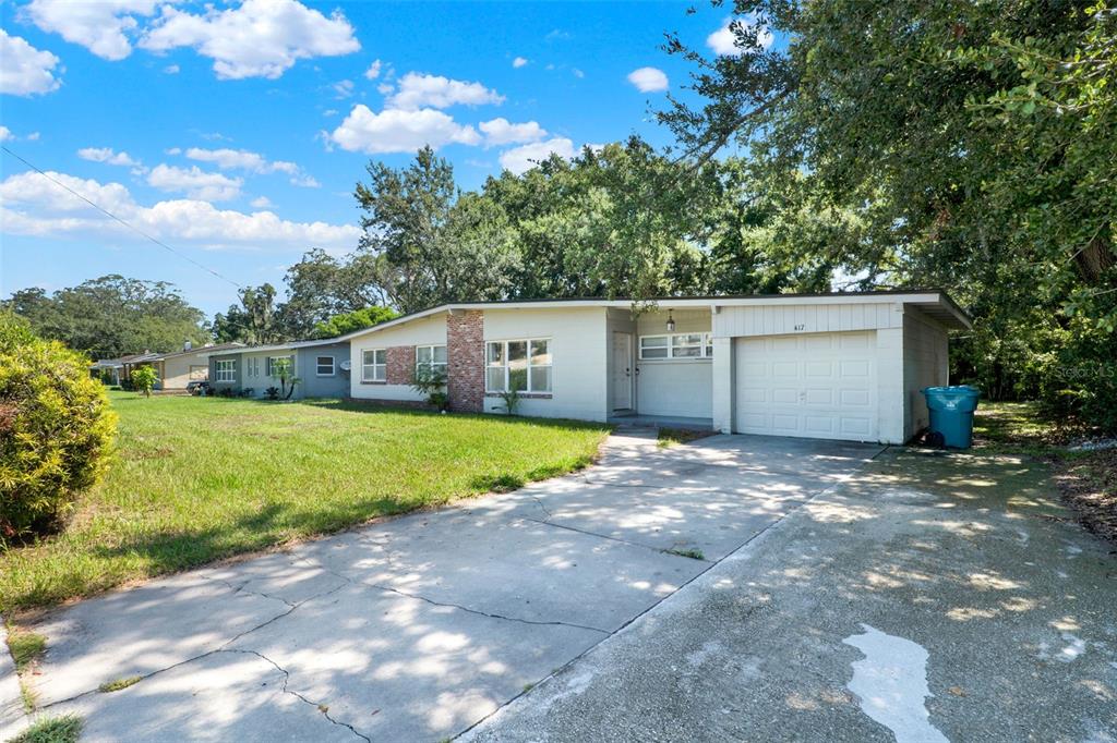 A single-story house with a white exterior, brick accents, and an attached garage — 417 N TAMPA AVENUE, ORLANDO, FL