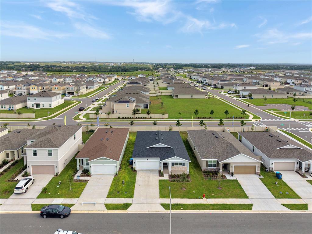 An aerial view shows a row of suburban houses with driveways and a nearby neighborhood — 4136 LAVENDER COURT, LAKE HAMILTON, FL