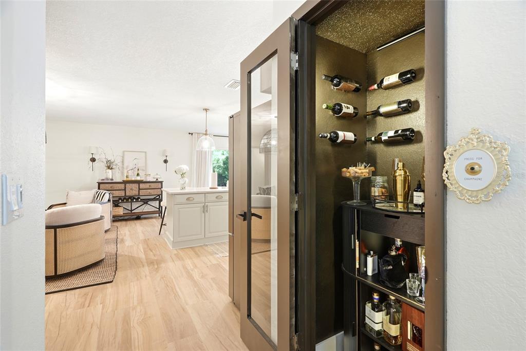 A view into a home bar closet with wine racks and a glass door — 8 CLEARVIEW DRIVE, SAFETY HARBOR, FL
