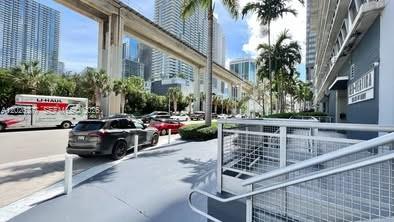 A street-level view shows a parking area, a U-Haul truck, and an elevated train track — 690 SW 1st Ct # 1908, Miami FL 33130, MIAMI, FL