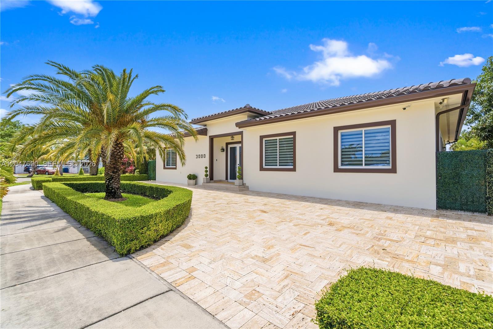 A single-story house with a paved driveway, a palm tree, and manicured hedges — 3000 SW 103rd Ave, Miami FL 33165, MIAMI, FL