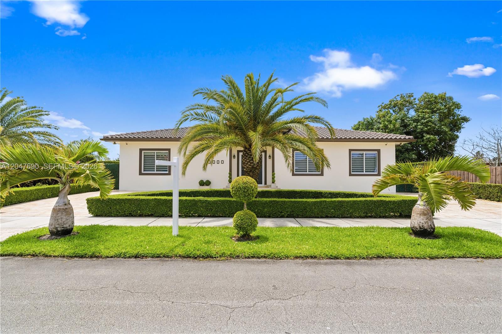 A single-story house with a palm tree, manicured hedges, and a lawn under a blue sky — 3000 SW 103rd Ave, Miami FL 33165, MIAMI, FL
