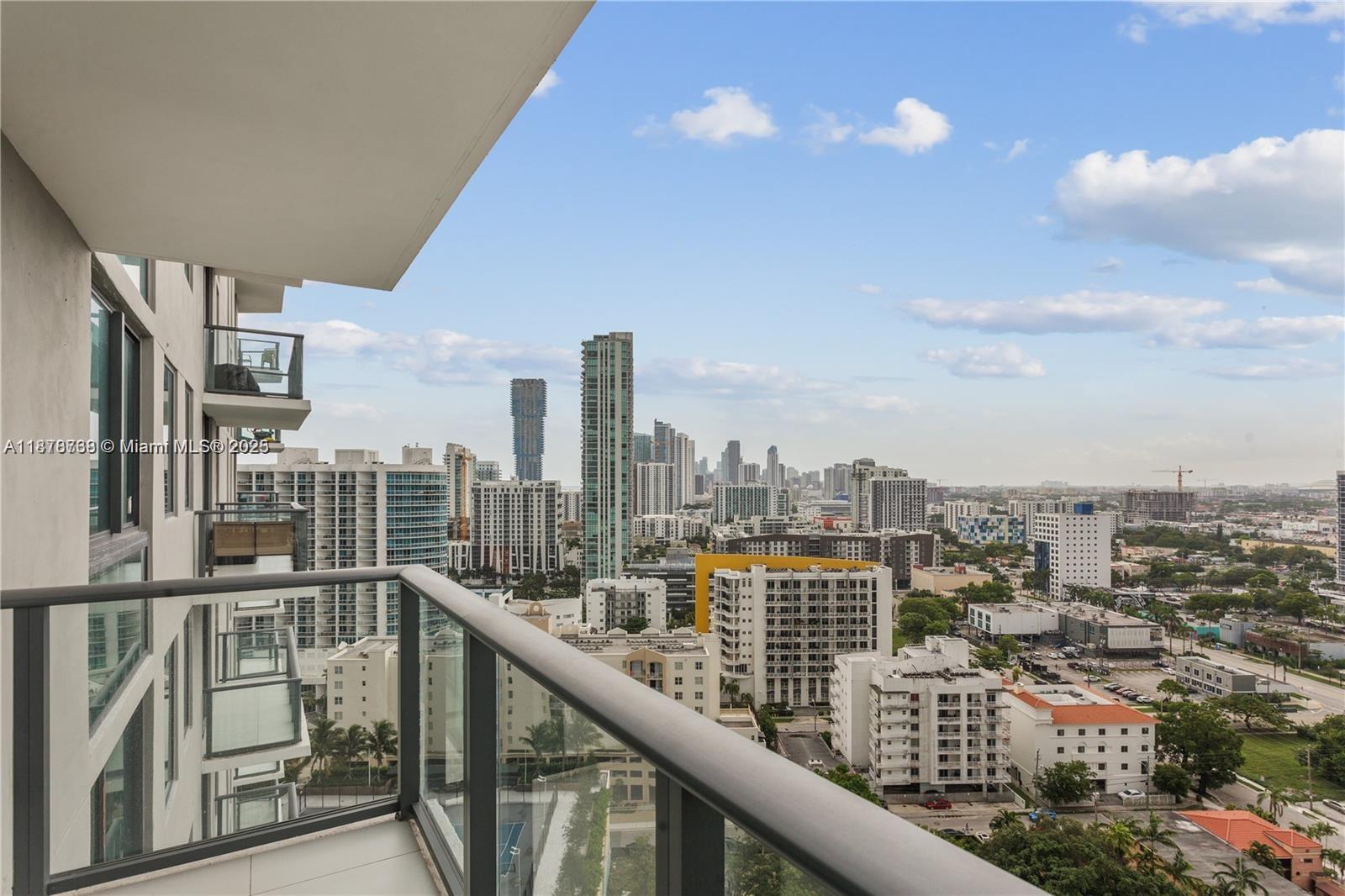A modern kitchen features white flat-panel cabinetry, stainless steel appliances, and light-colored countertops — 501 NE 31 street # 1709, Miami FL 33137, MIAMI, FL
