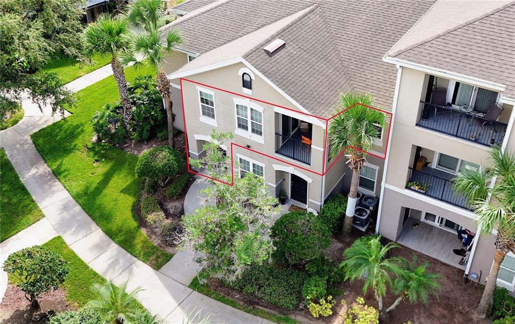 An aerial view shows the exterior of a multi-story apartment building with a red outline — 6548 SWISSCO DRIVE UNIT 628, ORLANDO, FL