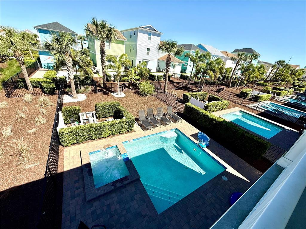 An elevated view shows a backyard with a swimming pool, hot tub, and lounge chairs — 8014 KNEE DEEP ROAD, KISSIMMEE, FL
