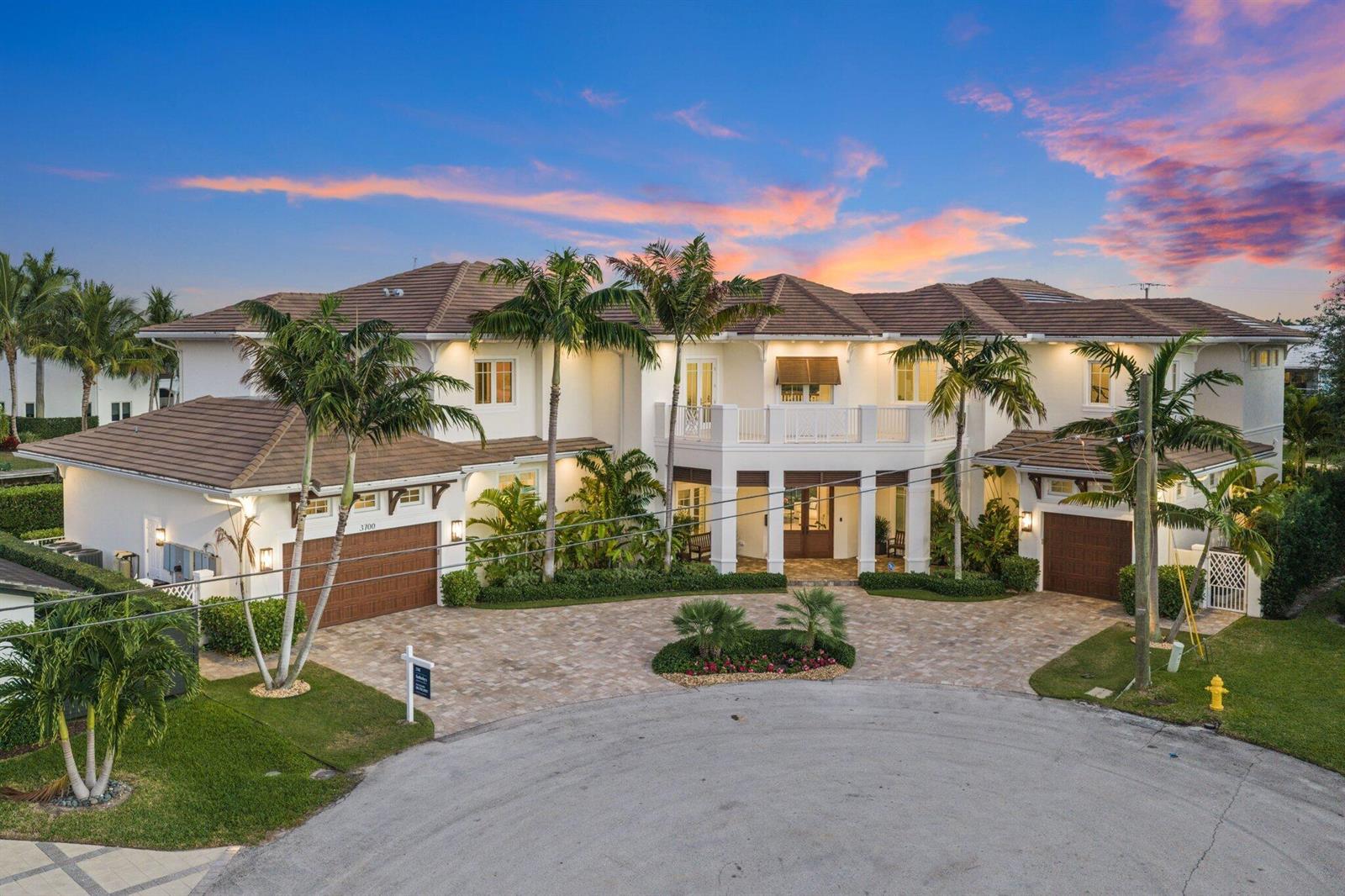 An exterior view of a large two-story house with a paved driveway and palm trees — 3700 NE 24th Avenue, Lighthouse Point FL 33064, LIGHTHOUSE POINT, FL