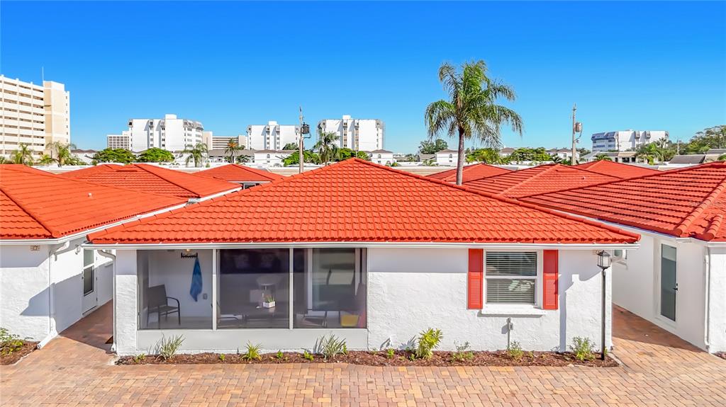 A white single-story house with a red tile roof and a screened-in porch — 6154 MIDNIGHT PASS ROAD UNIT 6-C, SARASOTA, FL