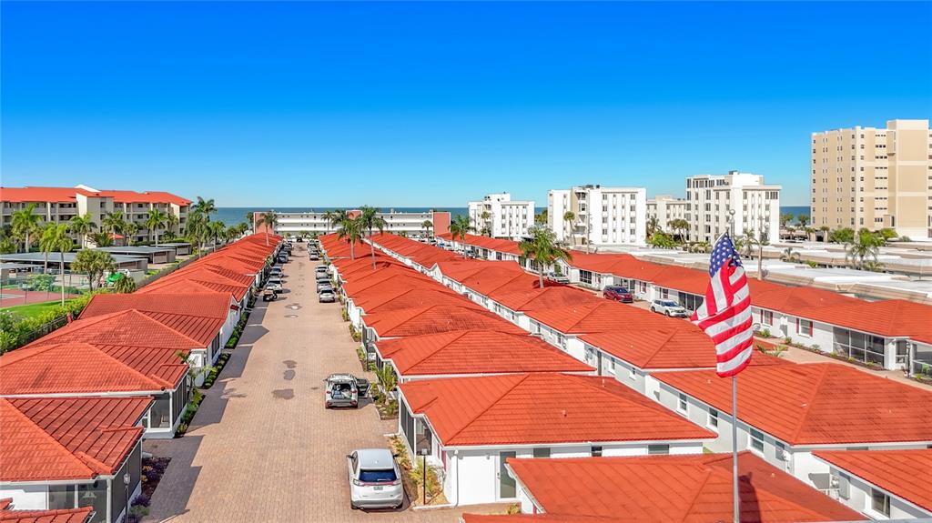 An aerial view shows rows of single-story residential units with red tile roofs — 6154 MIDNIGHT PASS ROAD UNIT 6-C, SARASOTA, FL