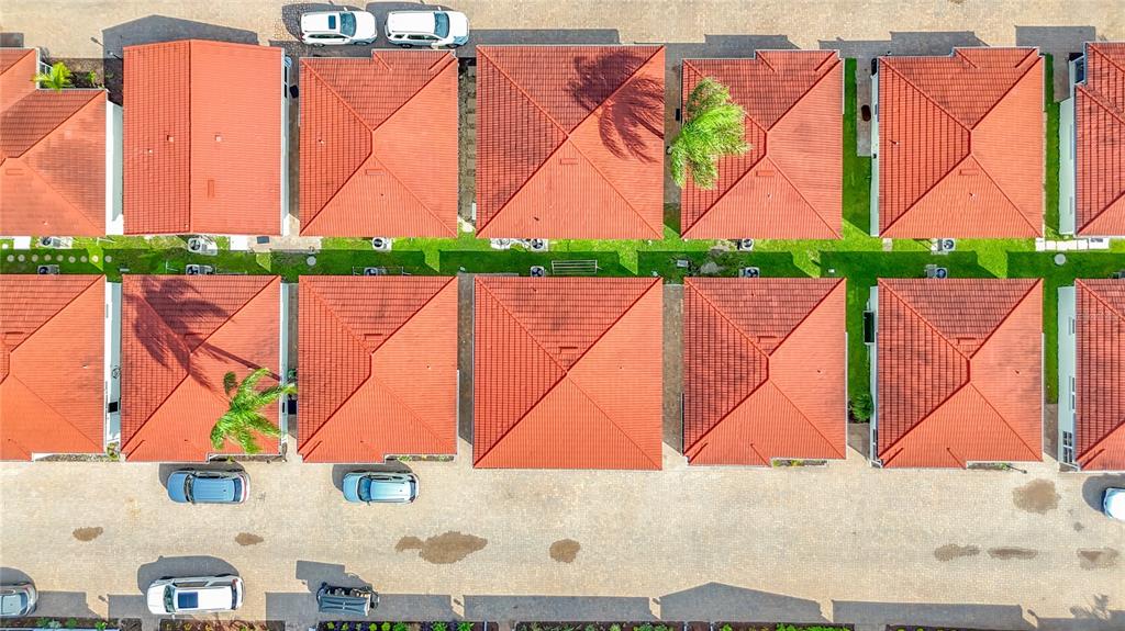 An aerial view shows a row of houses with red tiled roofs and parked cars — 6154 MIDNIGHT PASS ROAD UNIT 6-C, SARASOTA, FL