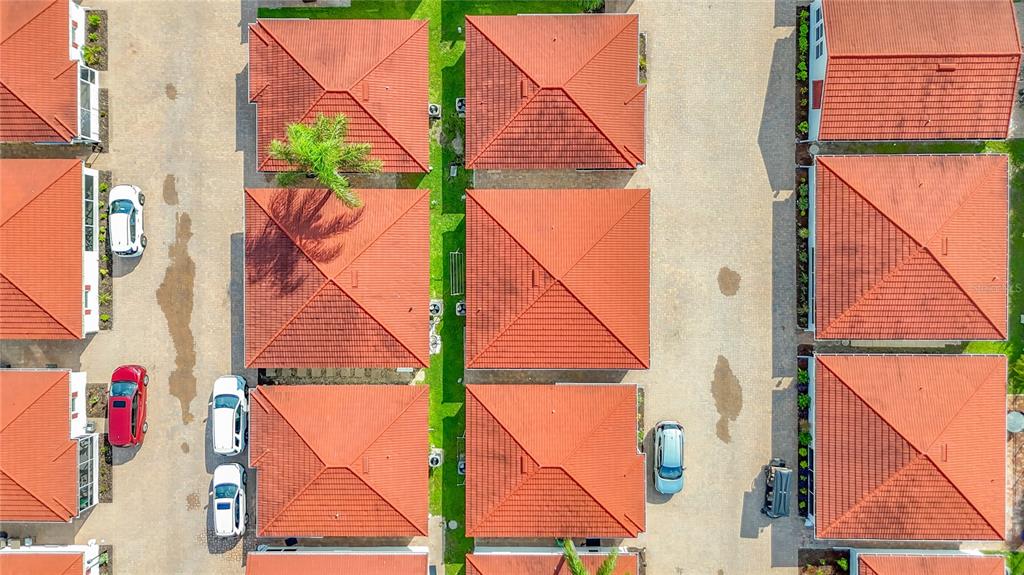 An aerial view shows several residential buildings with red tiled roofs and parked cars — 6154 MIDNIGHT PASS ROAD UNIT 6-C, SARASOTA, FL