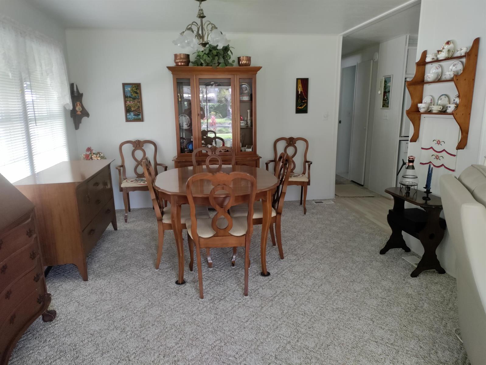 A dining room features a wooden table and chairs, a china cabinet, and carpeted flooring — 8270 South Street, Boca Raton FL 33433, BOCA RATON, FL