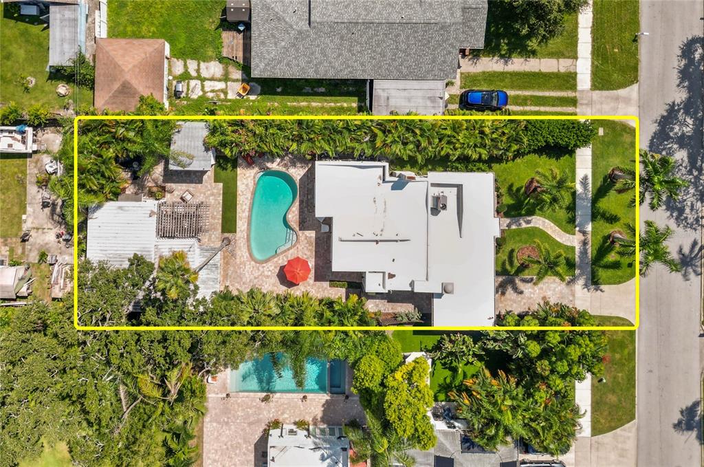 Aerial view of a residential property featuring a swimming pool and a landscaped backyard — 219 N MISSOURI AVENUE, CLEARWATER, FL