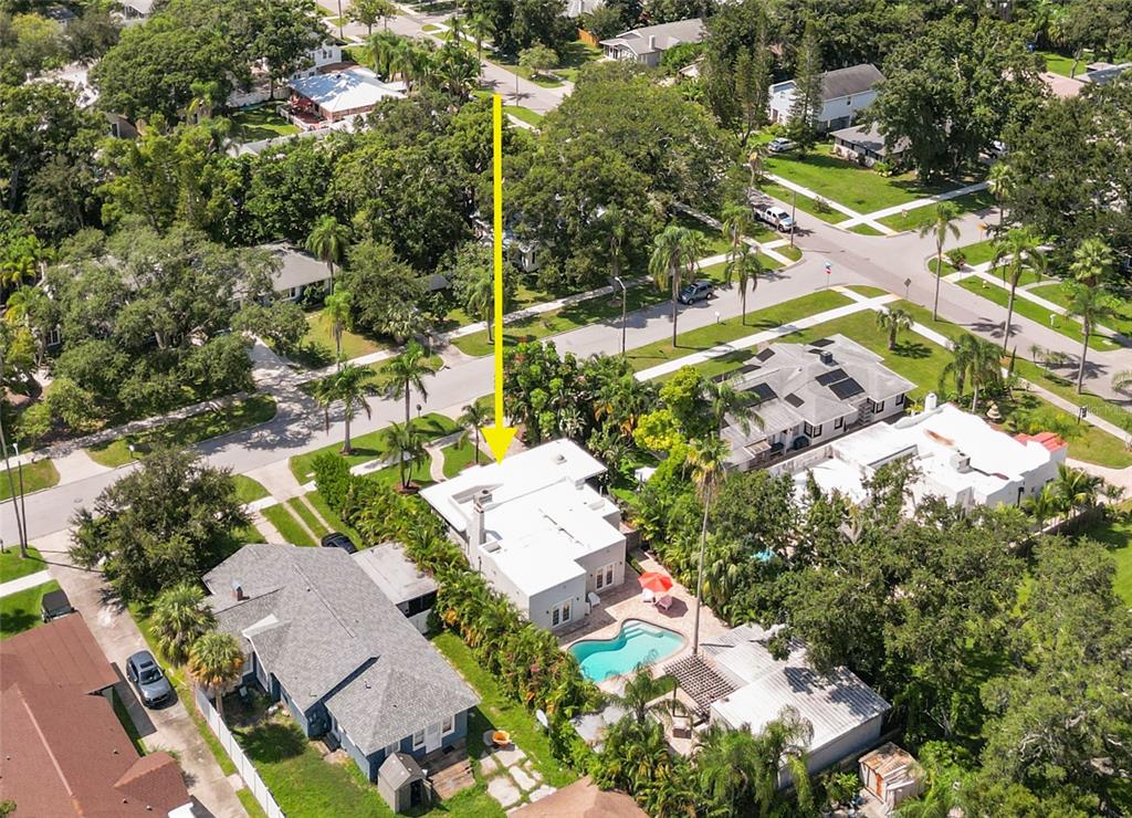 An aerial view shows a house with a white roof, a swimming pool, and landscaping — 219 N MISSOURI AVENUE, CLEARWATER, FL