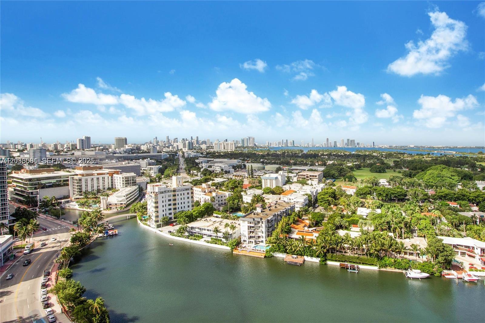 An aerial view shows a waterway winding through a residential area with lush landscaping — 2555 Collins Ave # 2204, Miami Beach FL 33140, MIAMI BEACH, FL