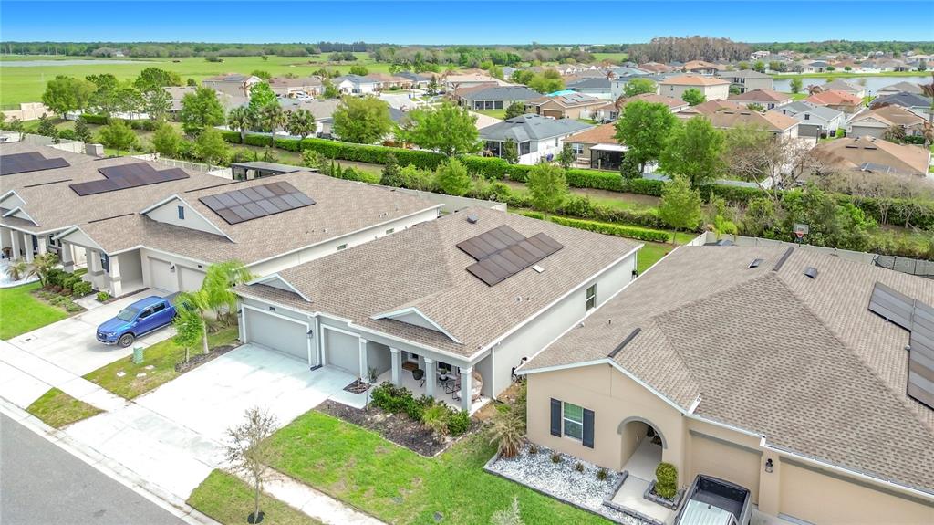 An aerial view shows several suburban houses with shingled roofs and solar panels — 4471 HOLSTEIN STREET, ST CLOUD, FL