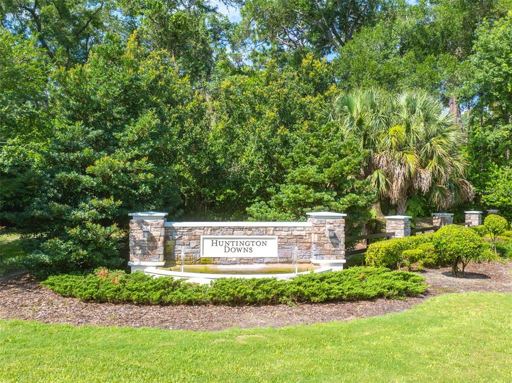 A stone monument sign for Huntington Downs sits in front of lush trees and landscaping — 111 POINT PLEASANT ROAD, DELAND, FL