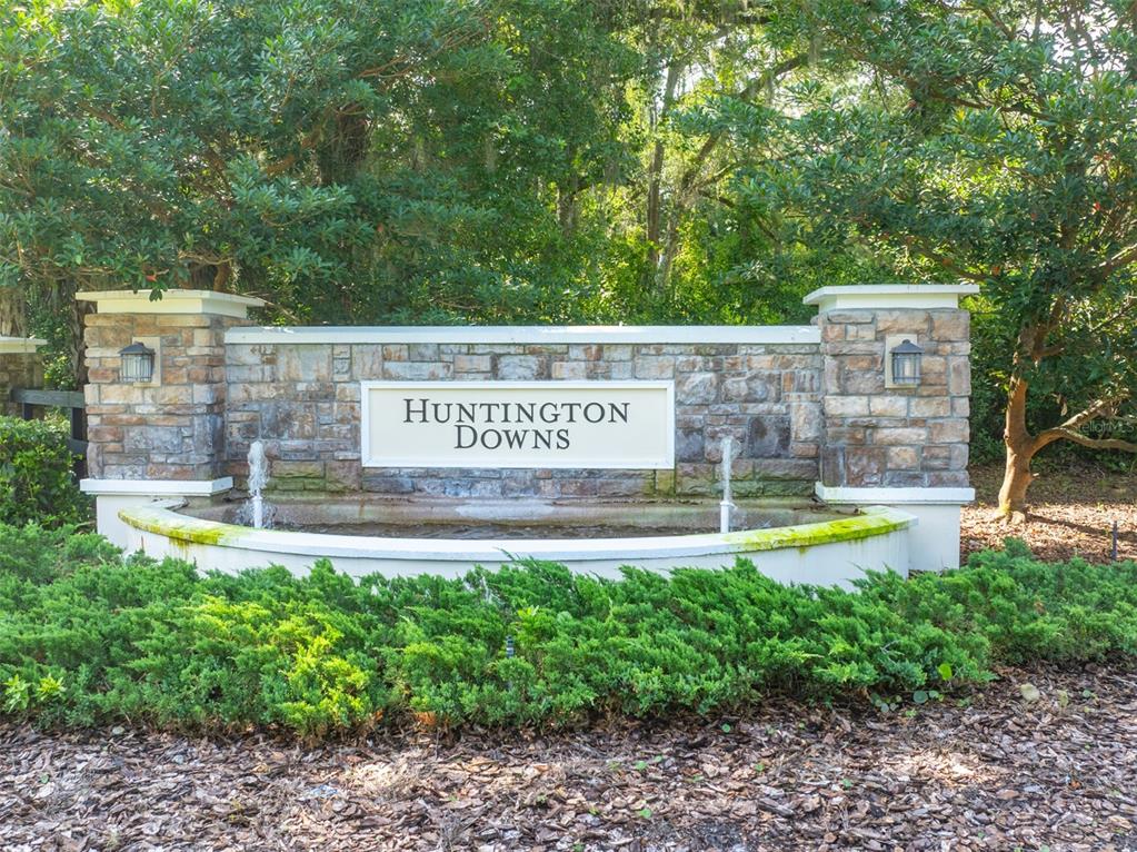 A stone monument sign for Huntington Downs features a small fountain and lush landscaping — 111 POINT PLEASANT ROAD, DELAND, FL