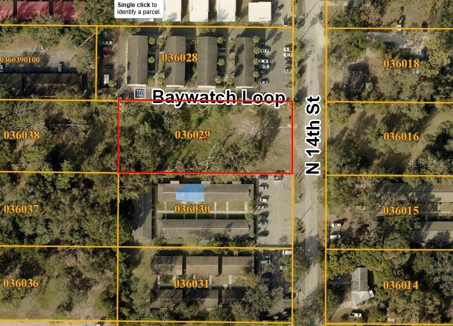 This is an aerial map showing a vacant lot outlined in red near a street — 11724 N 14TH STREET, TAMPA, FL
