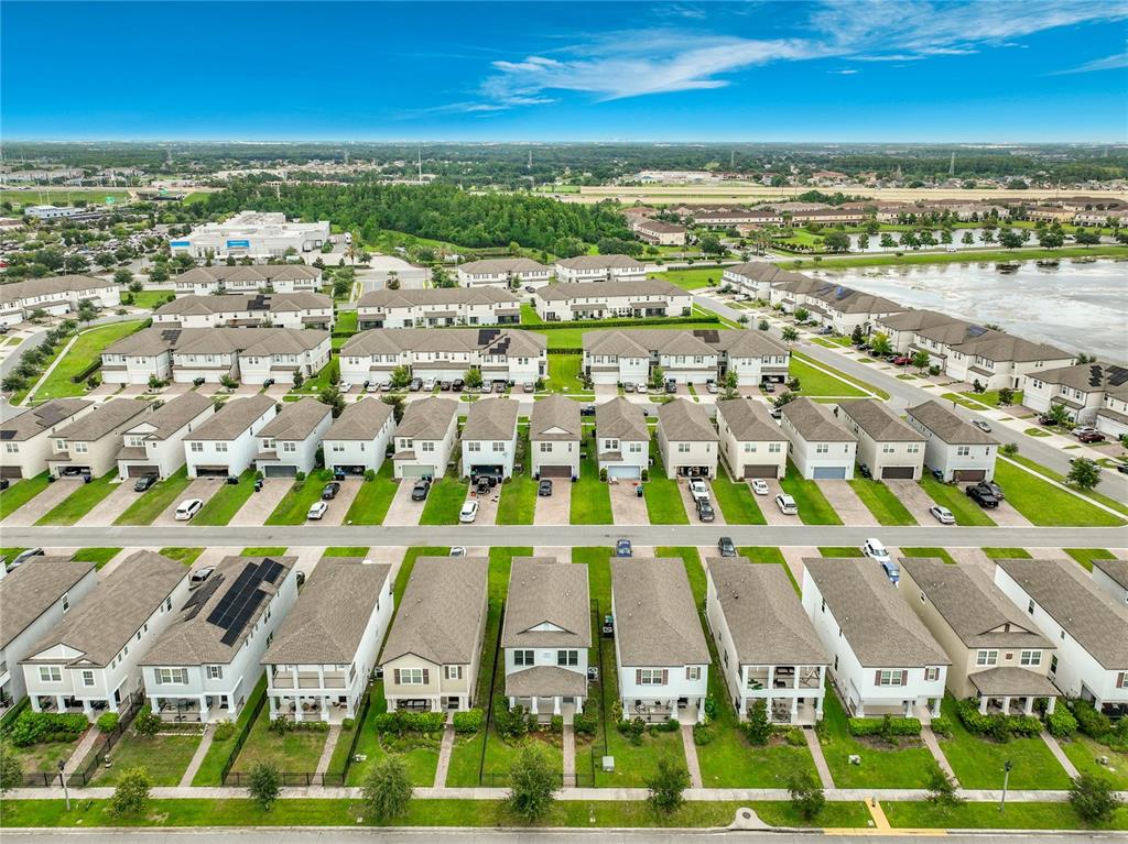 An aerial view shows rows of suburban houses with driveways and green lawns — 1549 ASTORIA ARBOR LANE, ORLANDO, FL