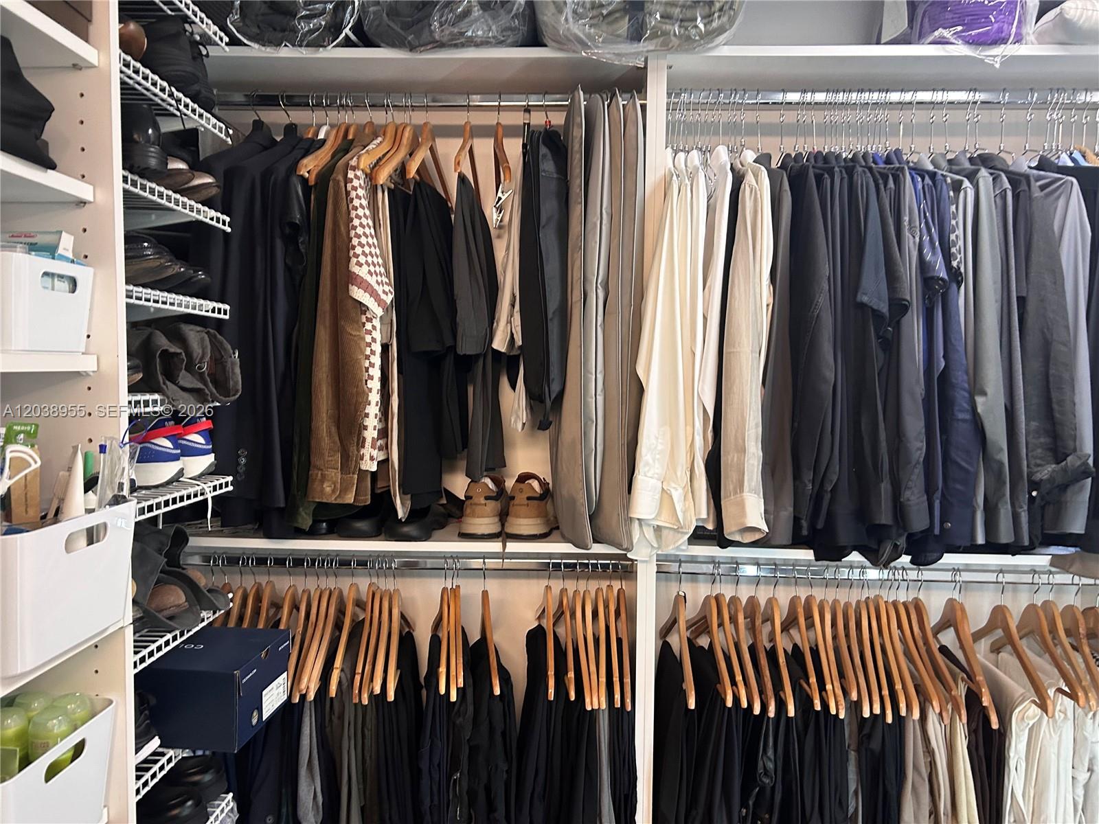 A walk-in closet features organized clothing racks, shelving units, and storage bins — 600 NE 36th St # 1017, Miami FL 33137, MIAMI, FL