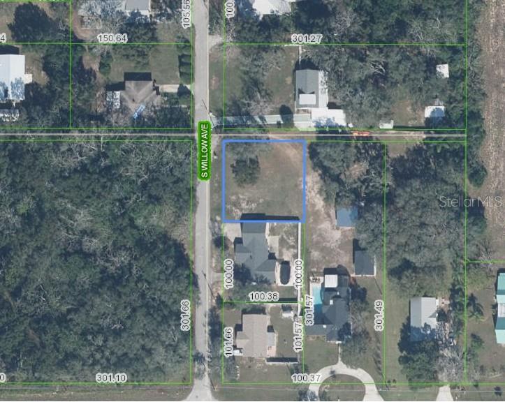 An aerial map shows a vacant rectangular lot highlighted in blue along a paved road — 611 S WILLOW AVENUE, AVON PARK, FL