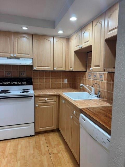 A kitchen features light wood cabinets, a white stove, a sink, and a dishwasher — 14321 N Kendall Dr # 403F, Miami FL 33186, MIAMI, FL
